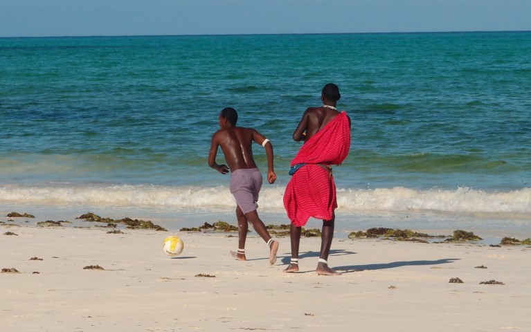 Masai people playing football on the beach