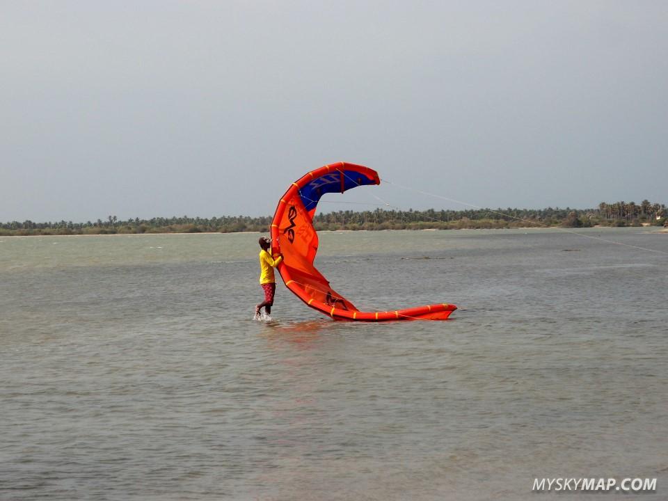 Beach boy launching a kite at Sri Lanka Kite